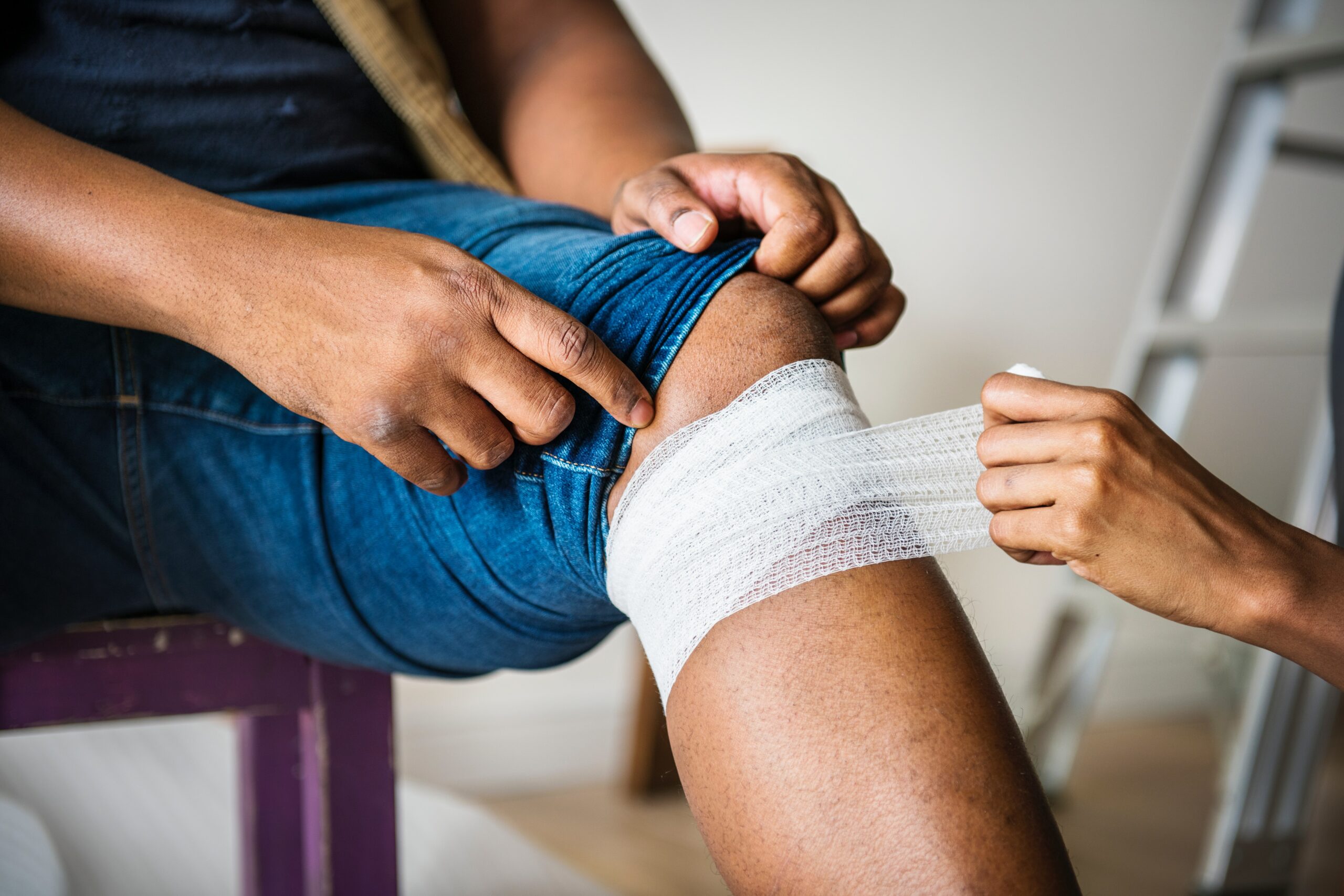 Wrapping gauze around an unseen leg injury